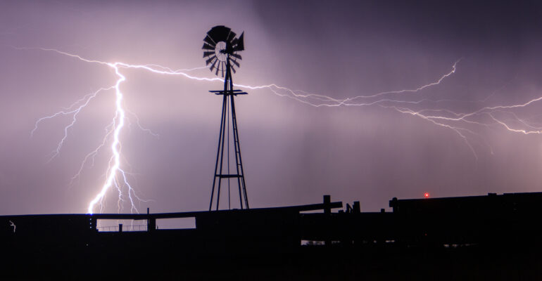 Lightning strikes behind a windmill in Western Oklahoma